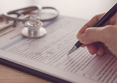 person filling out medical form